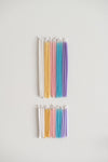 Rainbow of pastel gala beeswax candles above birthday beeswax candles.