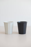 KINTO Japan Alfresco tumblers in beige and black beside each other from the side view.