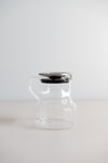 KINTO Cast glass teapot with stainless steel lid side view.
