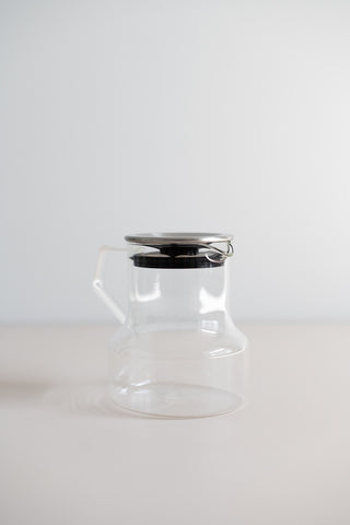 KINTO Cast glass teapot with stainless steel lid side view.