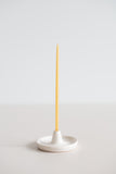 Natural beeswax gala candle in a handmade ceramic candle holder.